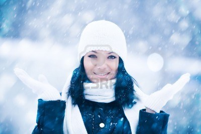 7873223-winter-portrait-of-beautiful-smiling-woman-with-snowflakes.jpg